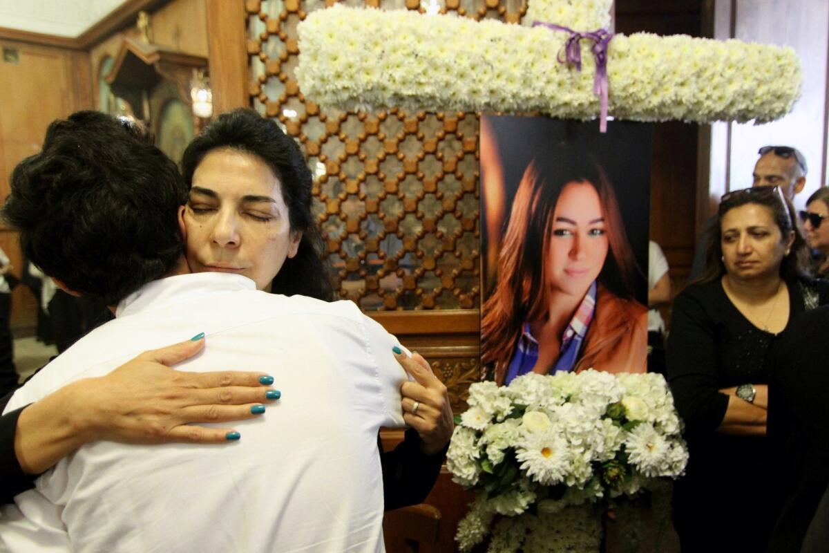 Relatives and friends of EgyptAir flight attendant hostess Yara Hani (portrait), who was on Flight MS804 from Paris to Cairo when it plunged into the Mediterranean, mourn during a ceremony at a Cairo church. (AFP/Getty Images)