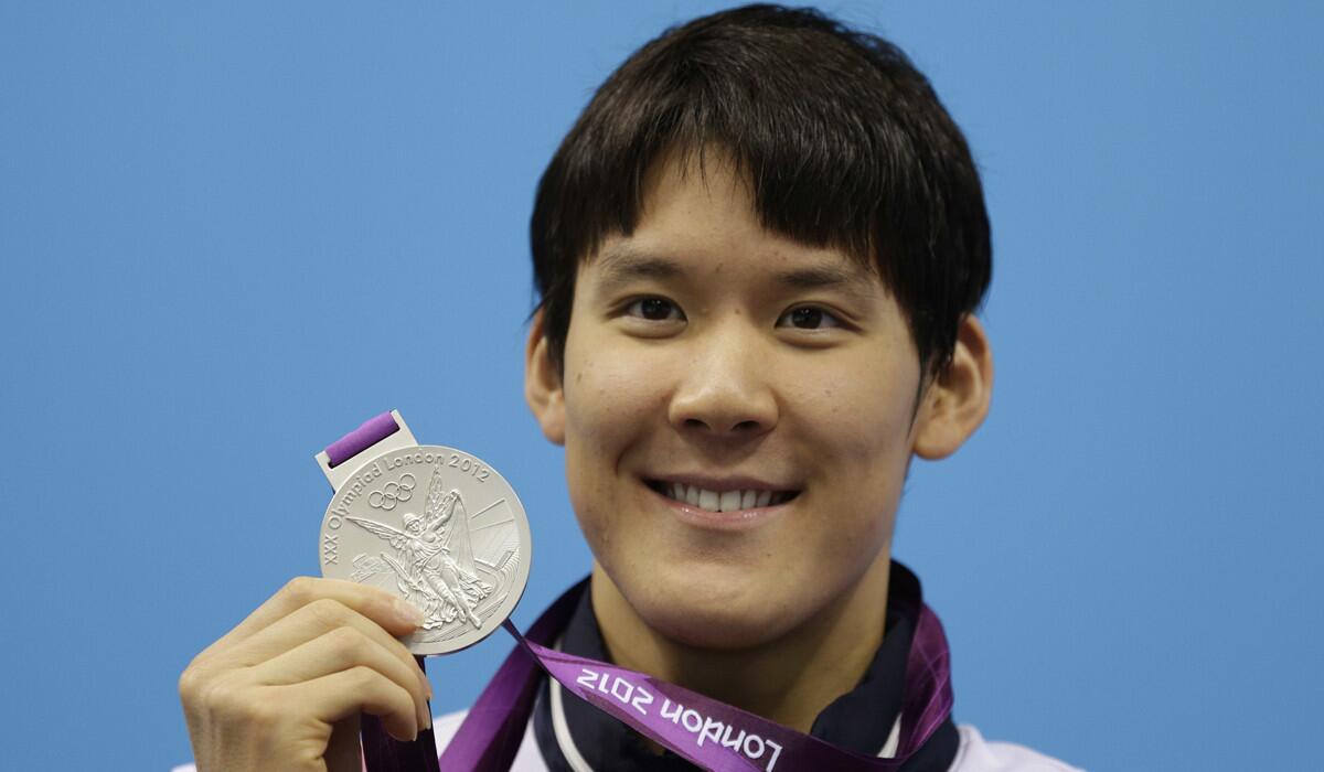 South Korea's Park Tae-hwan poses with his silver medal for the men's 200-meter freestyle swimming final during the 2012 London Olympics.