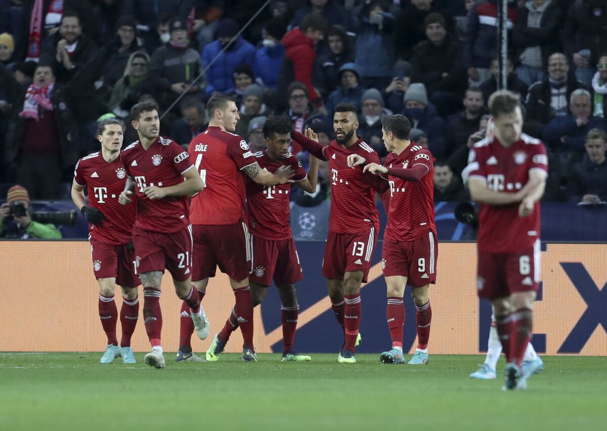 Bayern's Kingsley Coman celebrates with teammates after scoring his side's opening goal during the Champions League, round of 16, first leg soccer match between Salzburg and Bayern, at the Salzburg stadium, in Salzburg, Austria, Wednesday, Feb. 16, 2022. (AP Photo/Alexandra Beier)