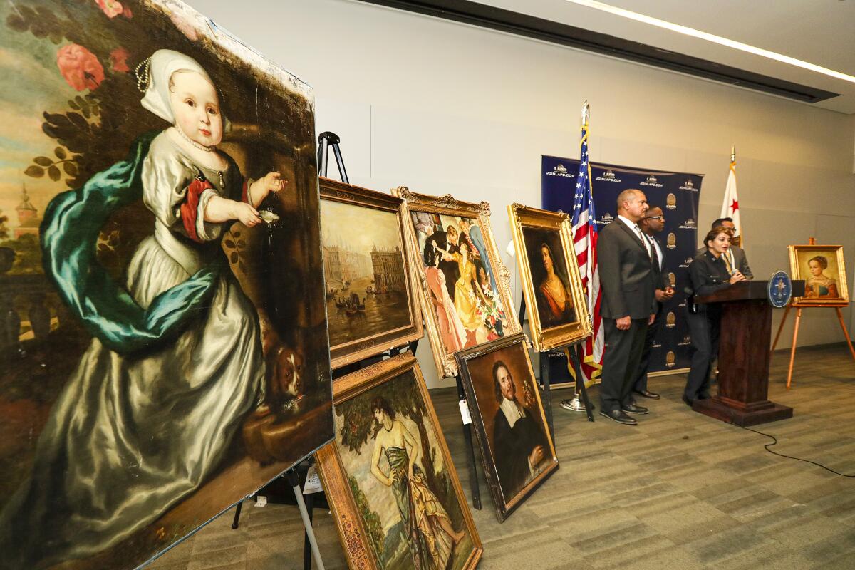 Paintings on easels at a police news conference  