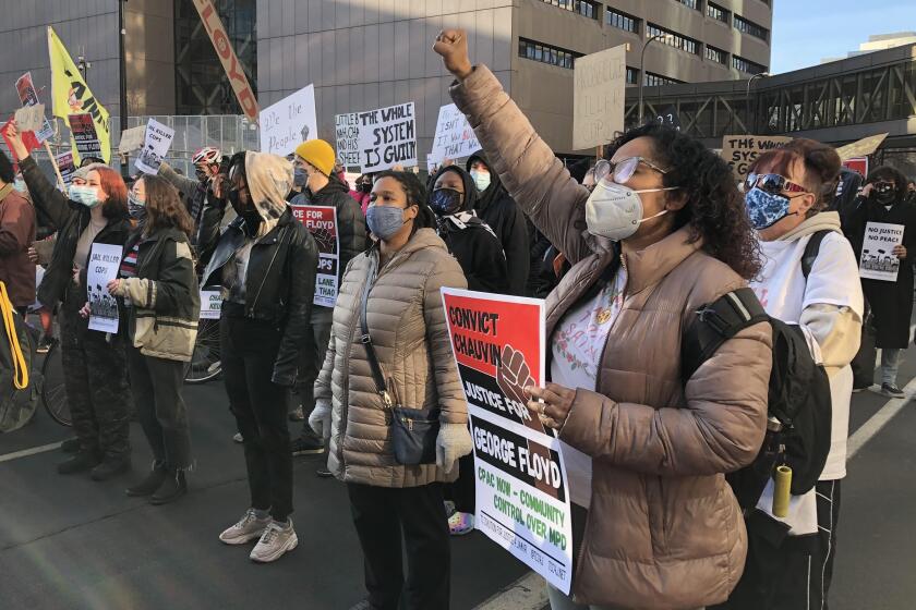 Samantha Pree-Gonzalez, (right) protests outside the courthouse in downtown Minneapolis where former police officer Derek Chauvin is standing trial for the murder of George Floyd.