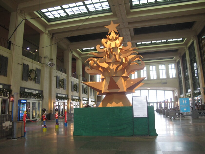 This Nov. 26, 2021 photo shows "The Giving Tree," a Christmas tree display made out of cardboard at Asbury Park NJ's Convention Hall that is delighting many in the seaside town, but dismaying others who miss the fresh-cut natural tree that is usually on display there during the holidays. (AP Photo/Wayne Parry)