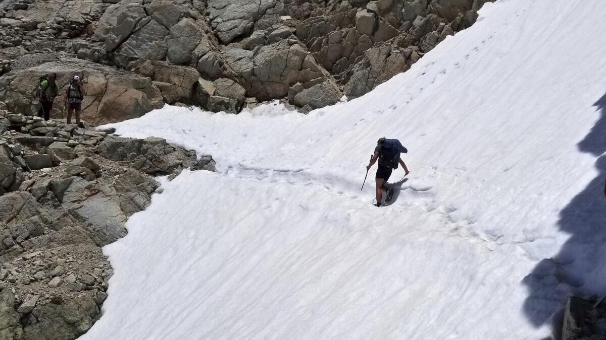 Hikers cross a snowfield in Sequoia National Park along the Pacific Crest Trail near Kings Canyon National Park in 2017.