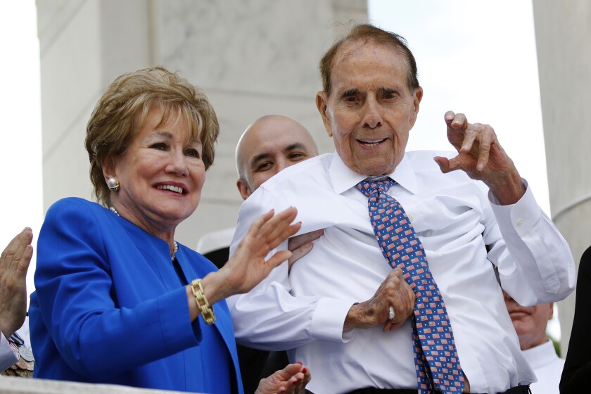 FILE - Former Sen. Bob Dole, right, and his wife Elizabeth Dole acknowledge well-wishers during a Memorial Day ceremony, Monday, May 27, 2019, at Arlington National Cemetery in Arlington, Va. Dole will be buried Wednesday, Feb. 2, 2022, at Arlington National Cemetery. (AP Photo/Patrick Semansky, File)