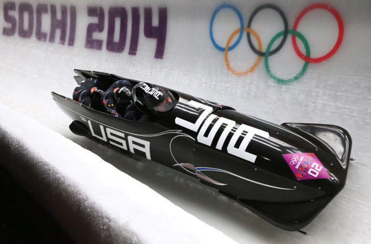 Pilot Steven Holcomb guides USA 1 with bobsled team members Curtis Tomasevicz, Steven Langton and Christopher Fogt aboard during a run Saturday at the Sliding Center Sanki.