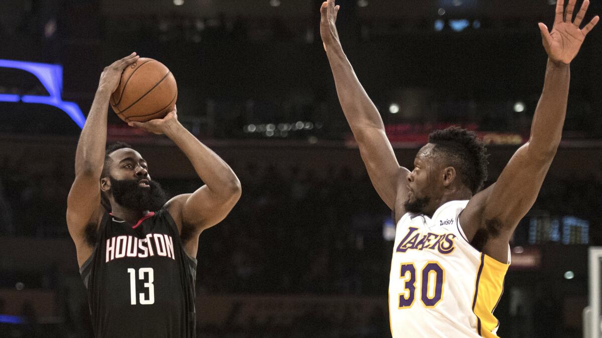 Rockets guard James Harden attempts a three-pointer over Lakers forward Julius Randle during the first half Sunday.