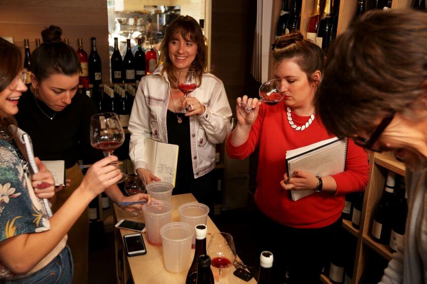 LOS ANGELES, CA. -- TUESDAY, APRIL 31, 2017 -- Helen Johannessen, 34, center, in her wine shop, Helen's Wines, which sits in the middle of Jon & Vinny's restaurant. Johannessen's employees are Bethany Kocak, 25, Molly Kelley, 28, and Heather Newman, 26, as they all test wine brought in by Robert Brownson, 47, right, of Farm Wine Imports. ( Rick Loomis / Los Angeles Times )