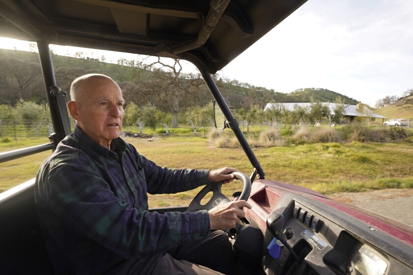 Former California Gov. Jerry Brown uses an all-terrain vehicle to tour his ranch near Williams, Calif., Wednesday, March 2, 2022. Brown is living off the grid in retirement on a rural stretch of land his family has owned since the 19th century. But he's still deeply connected on climate change and the threat of nuclear war, two issues that have long captivated him. (AP Photo/Rich Pedroncelli)