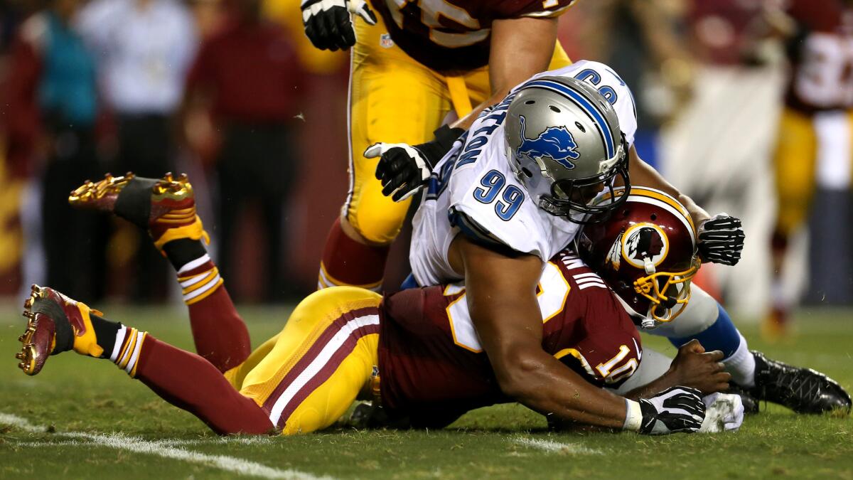 Washington quarterback Robert Griffin III is injured when trying to recover a fumble as Lions defensive lineman Corey Wootton lands on him.