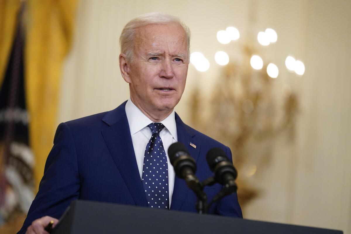 President Biden at a lectern with microphones