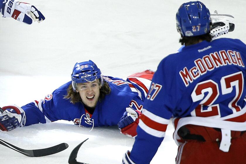 New York Rangers' Carl Hagelin, left, celebrates after scoring the winning goal in overtime of Game 5 against the Pittsburgh Penguins in the first round of the Stanley Cup playoffs on Friday. The Rangers won 2-1 to take the series and advance to the second round.
