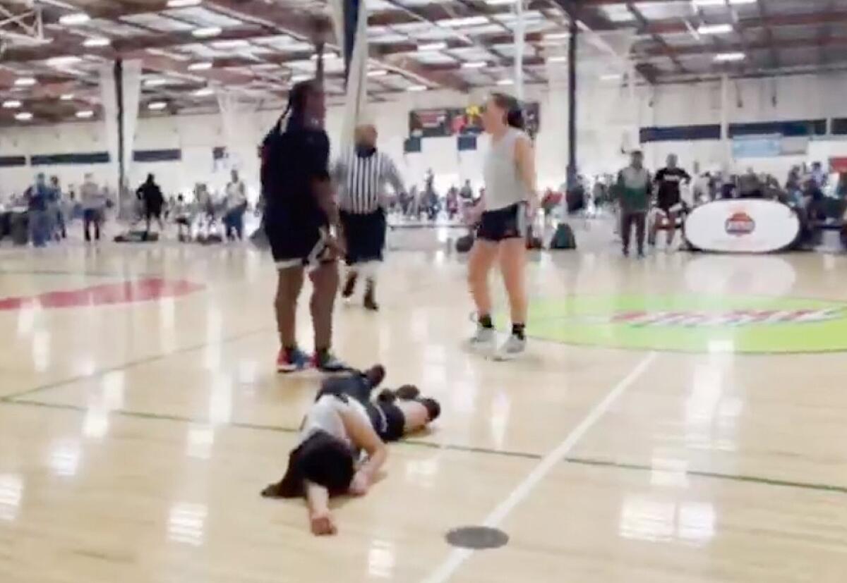 A player lies prone on a basketball court