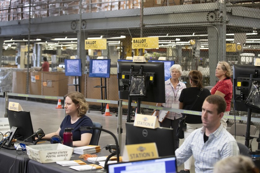 Observers from the Election Integrity Project watch ballots being processed in Orange County.