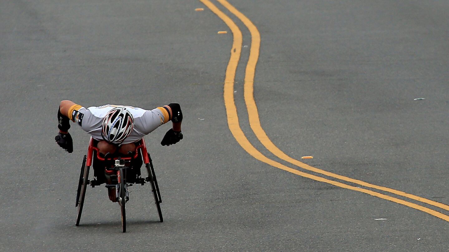 A wheelchair competitor powers to the finish line of the 30th Los Angeles Marathon in Santa Monica on Sunday.
