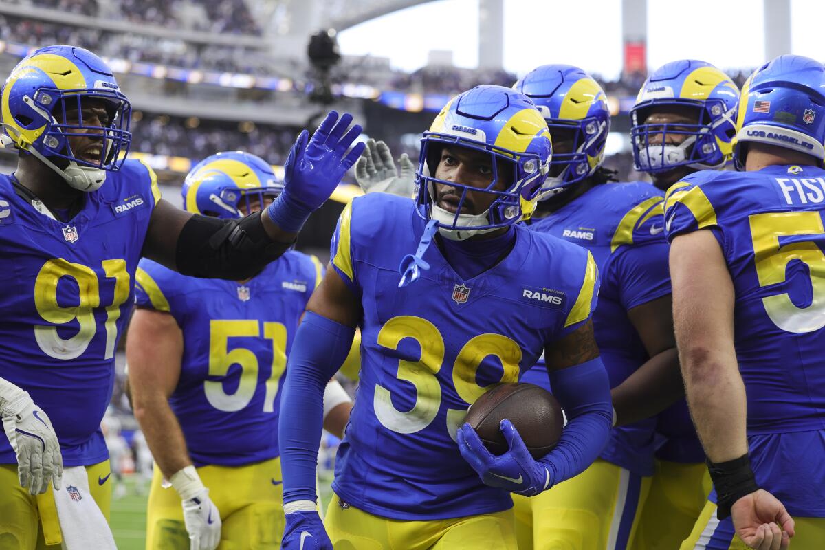 Rams safety Jaylen McCollough (39) celebrates with teammates after his game-sealing interception.