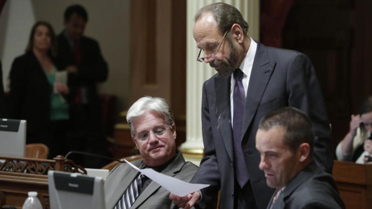 State Sen. Jerry Hill (D-San Mateo), center, discusses legislation with Sen. Andy Vidak (R-Hanford), left, and then-Sen. Steve Knight (R-Palmdale) in 2014.