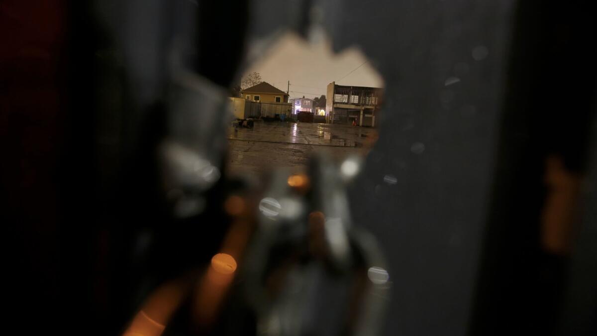 A view though a hole in the fence next to the warehouse at 1919 Market Street.