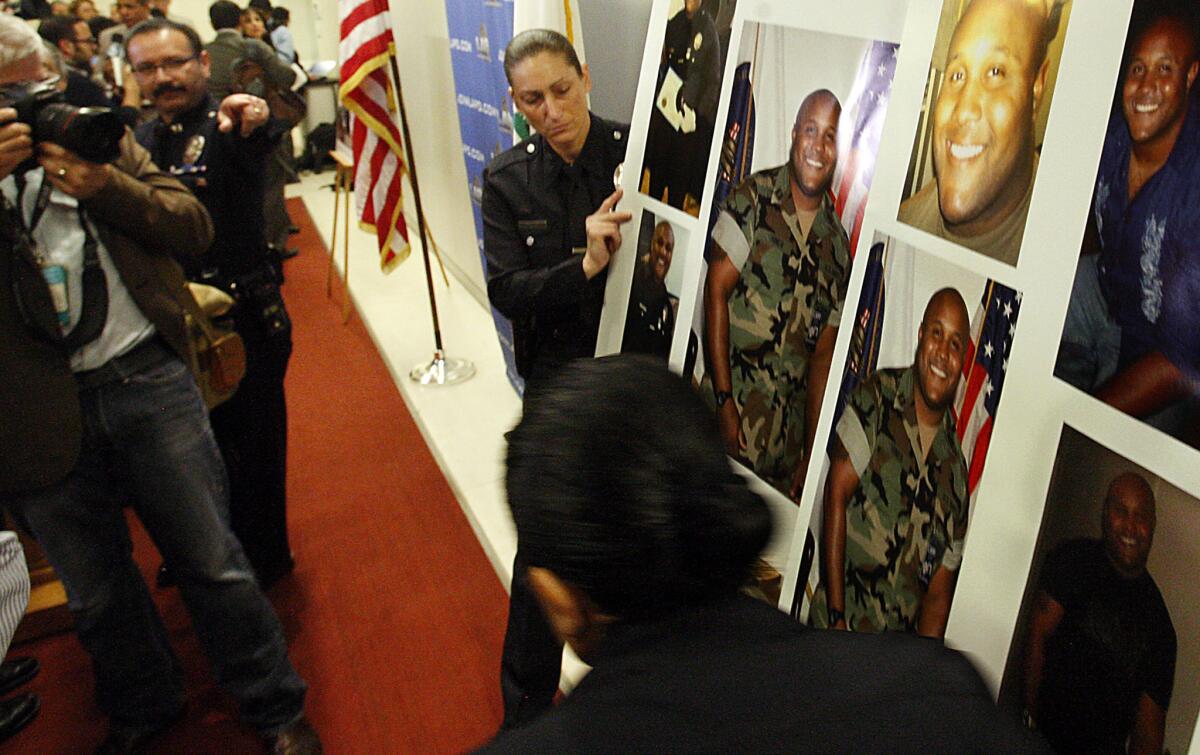 LAPD personnel display pictures of Christopher Dorner during a news conference at LAPD headquarters in Los Angeles.