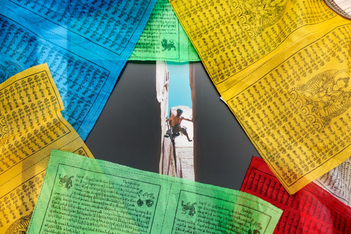 Michael Ybarra's Tibetan Prayer Flags surround a picture of him climbing.