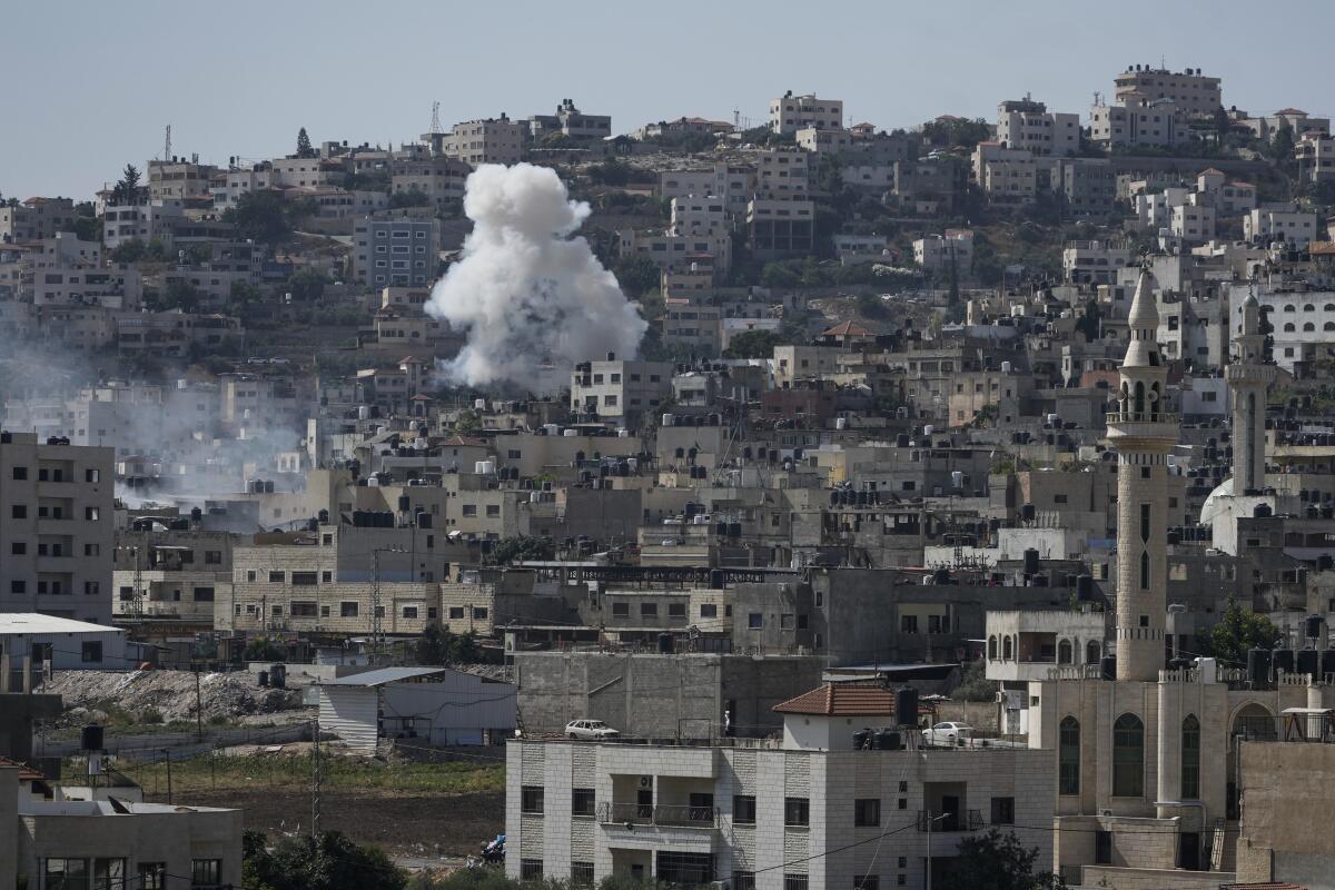 Smoke rising from the Palestinian militant stronghold of Jenin in the occupied West Bank