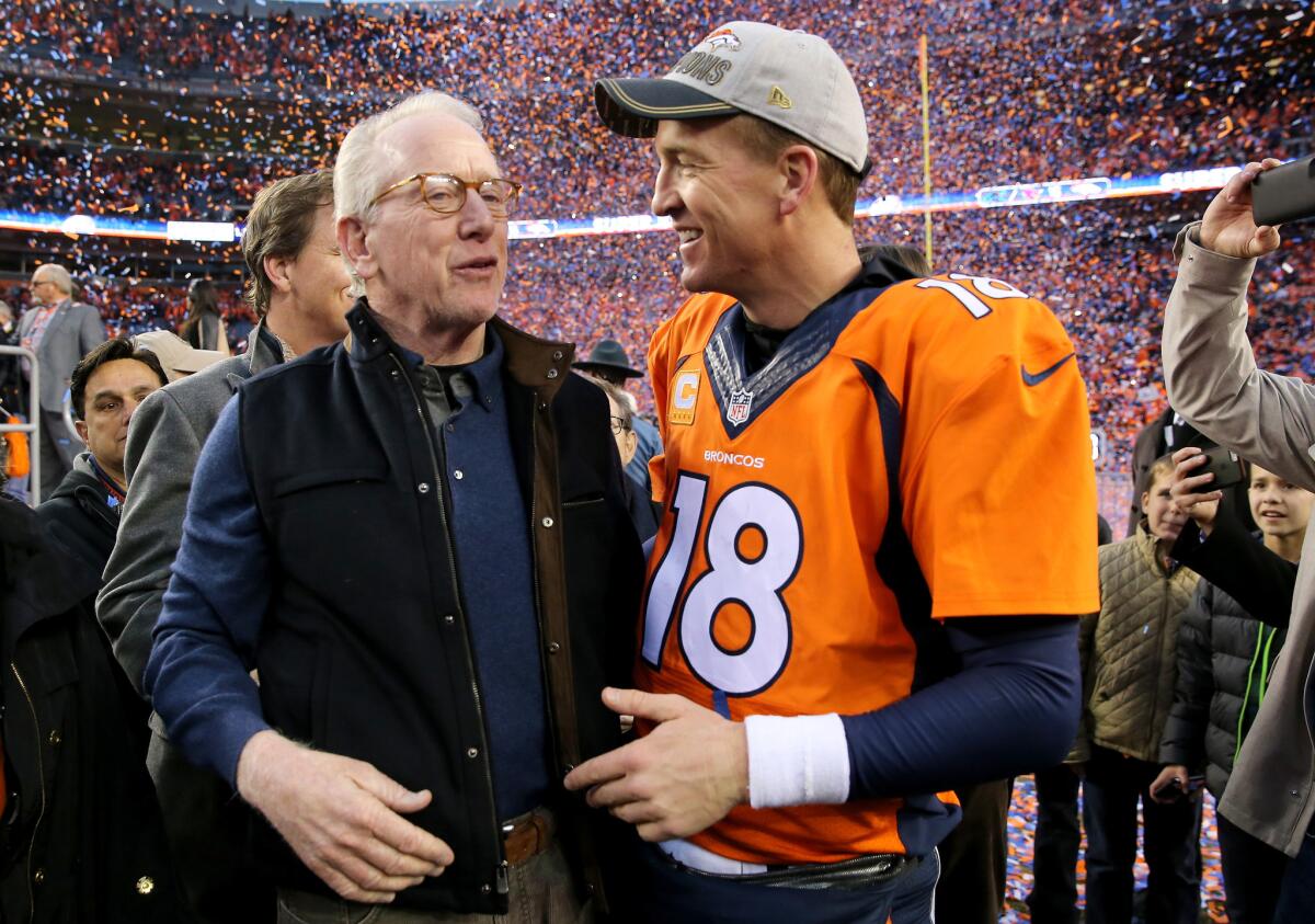 Denver quarterback Peyton Manning and his father, Archie Manning, walk off the field after the Broncos defeated New England in the AFC Championship game Jan. 24.