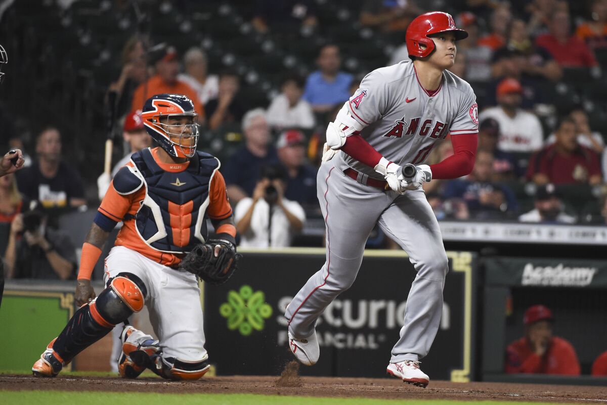 The Angels' Shohei Ohtani, right, watches his solo home run during the first inning Sept. 10, 2021.