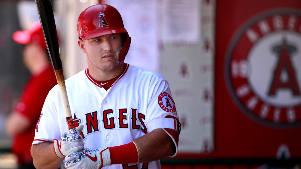 Angels star Mike Trout loosens up in the dugout before heading to the on-deck circle during a game against the Rangers.