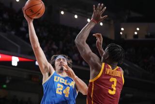 UCLA guard Jaime Jaquez Jr. shoots over USC forward Vincent Iwuchukwu 