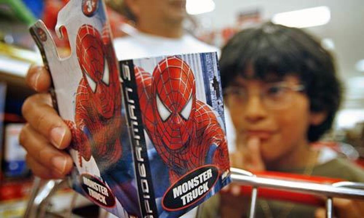 Gabriel Reynoso, 7, picked out a Spider-Man monster truck toy while shopping with his dad, Juan Reynoso (rear) and baby brother at Target. "Spider-Man 3," "Pirates of the Caribbean: At World's End" and "Transformers" all have toys modeled after the characters.