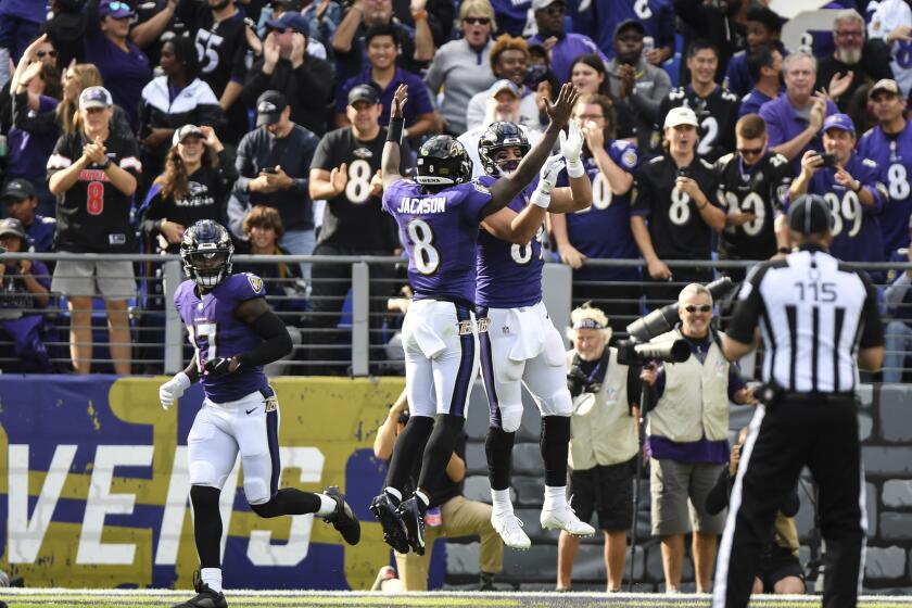 Ravens quarterback Lamar Jackson (8) celebrates with Mark Andrews after a TD pass against the Chargers in 2021.