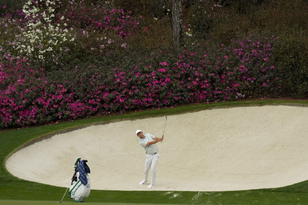 Scottie Scheffler hits out of a bunker on the 13th hole during a practice round for the Masters golf tournament Wednesday.