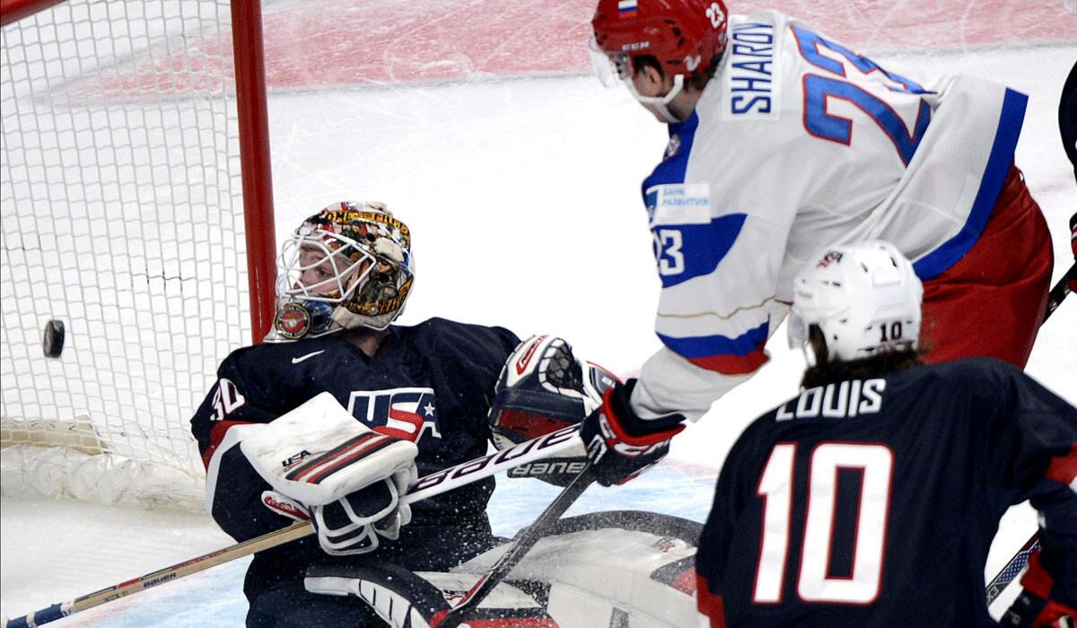 Russia's Alexander Sharov scores the second goal of the game in the first period against U.S. goaltender Thatcher Demko on Friday.