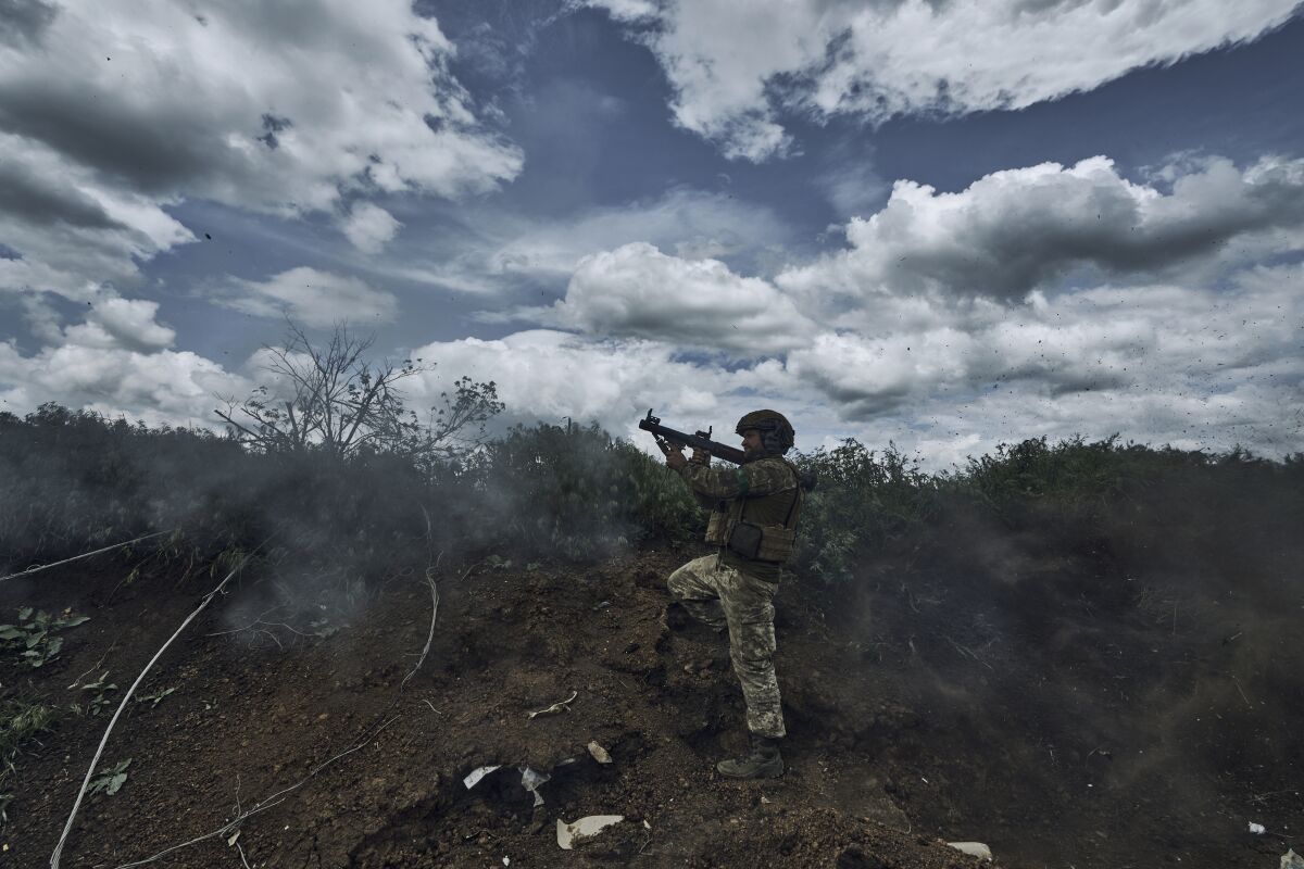 A Ukrainian soldier fires an RPG toward Russian positions at the frontline near Bakhmut in the Donetsk region, Ukraine, Monday, May 22, 2023. (AP Photo/Libkos)
