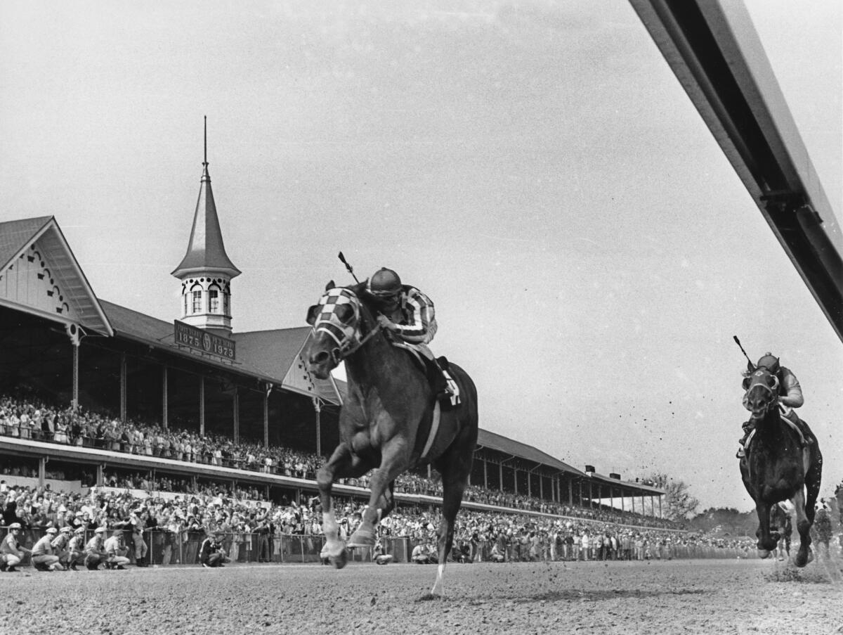 Secretariat, with jockey Ron Turcotte riding, passes the twin spires of Churchill Downs.
