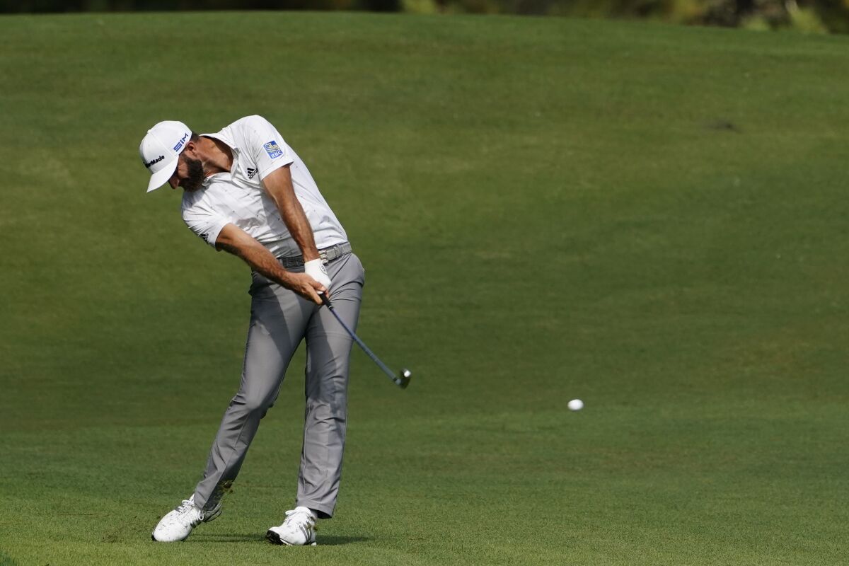 FILE - Dustin Johnson hits on the second fairway during the third round of the Masters golf tournament in Augusta, Ga., in this Saturday, Nov. 14, 2020, file photo. His 5-iron set up eagle and was a pivotal shot in his victory. (AP Photo/Matt Slocum, File)