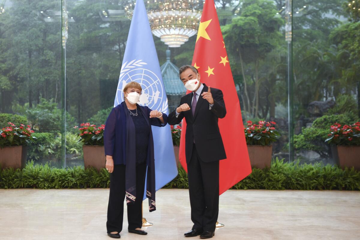 Chinese Foreign Minister Wang Yi, right, and United Nations High Commissioner for Human Rights Michelle Bachelet