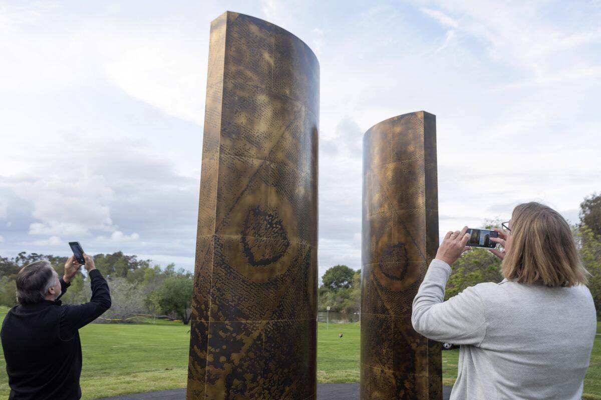 Artists David Dahlquist and Matt Niebuhr take pictures of their new public art installation.