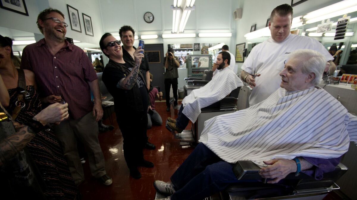Harlan Ellison, with fans, getting a haircut before a 2013 book signing.