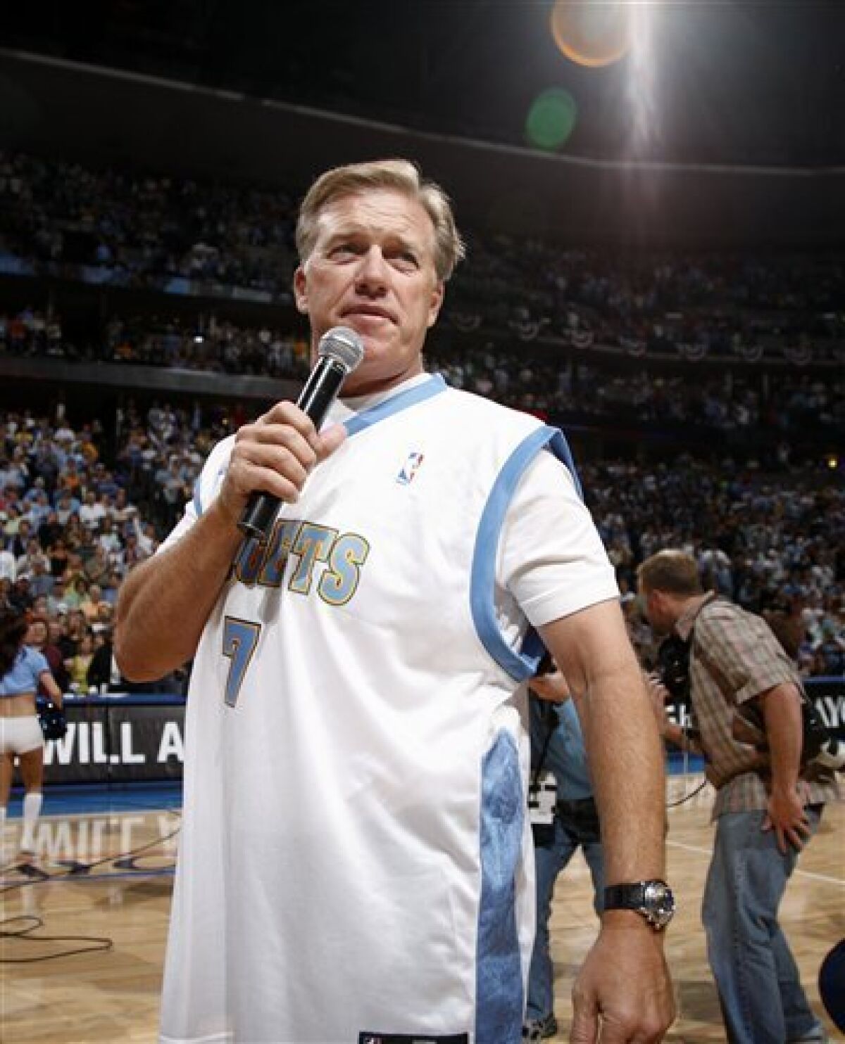 Retired Denver Broncos quarterback John Elway introduces the Denver Nuggets before the Nuggets played the Dallas Mavericks in the opening game of an NBA basketball Western Conference semifinal series in Denver on Sunday, May 3, 2009. (AP Photo/Jack Dempsey)