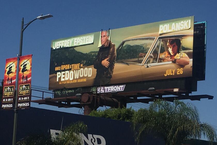 ONCE UPON A TIME IN HOLLYWOOD movie billboard on the south side of Pico at Alfred St, one block east of La Cienega, is altered to show Jeffrey Epstein's and director Roman Polanski's face over actors Leonardo Dicaprio and Brad Pitt. Note title change to Once Upon A Time in Pedowood.