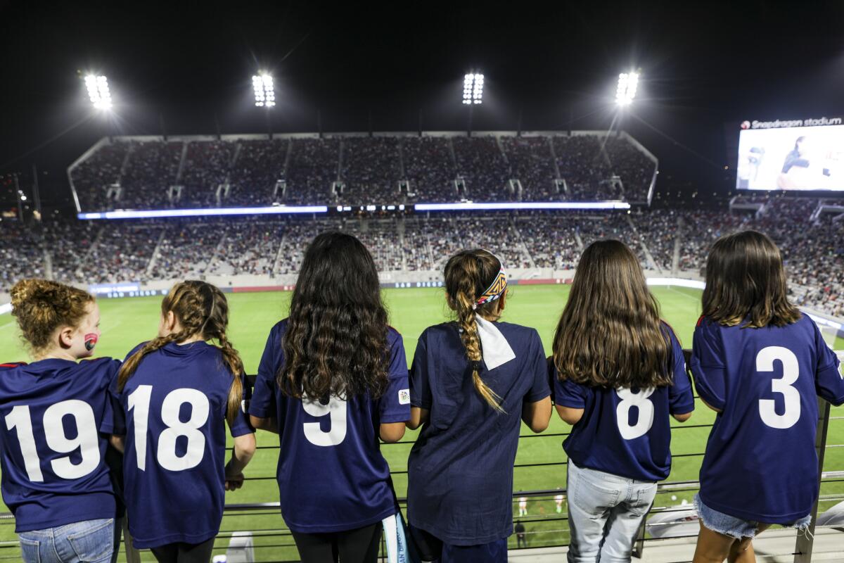 Members of a girls' soccer club watch the San Diego Wave play Angel City at Snapdragon Stadium.