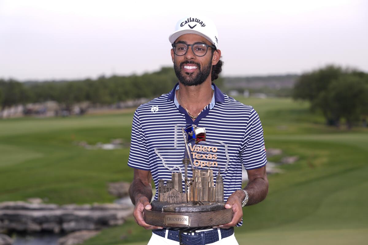 Akshay Bhatia holds the winner's trophy after capturing the Texas Open on Sunday.