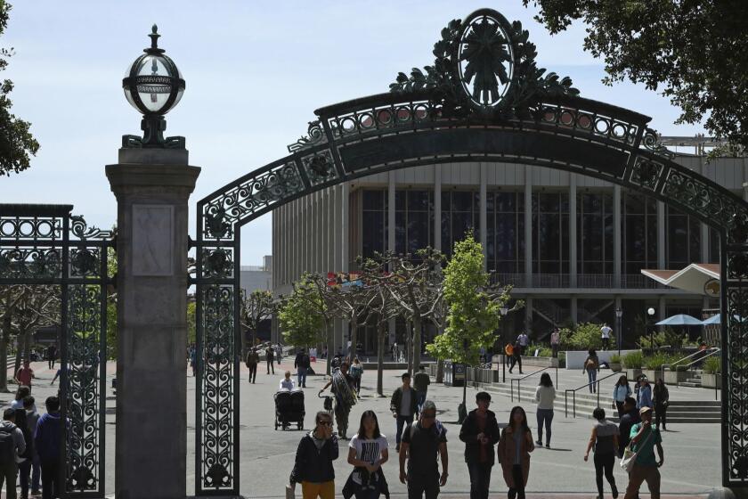 FILE - In this May 10, 2018, file photo, students walk past Sather Gate on the University of California at Berkeley campus in Berkeley, Calif. Choosing a college based on price can save you from overwhelming student debt, give your parents a break and increase the likelihood of a return on investment in your education. (AP Photo/Ben Margot, file)