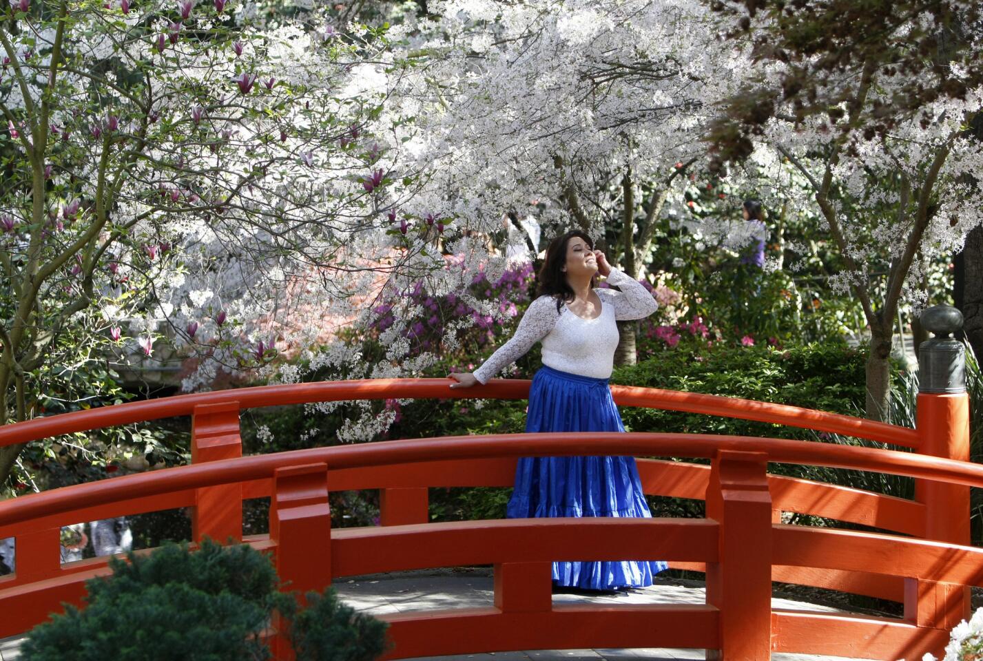 Olivia Baralla, 52 of Santa Clarita, poses for some photos on the Japanese Garden bridge at Descanso Gardens in La Cañada Flintridge on Friday, March 24, 2017.