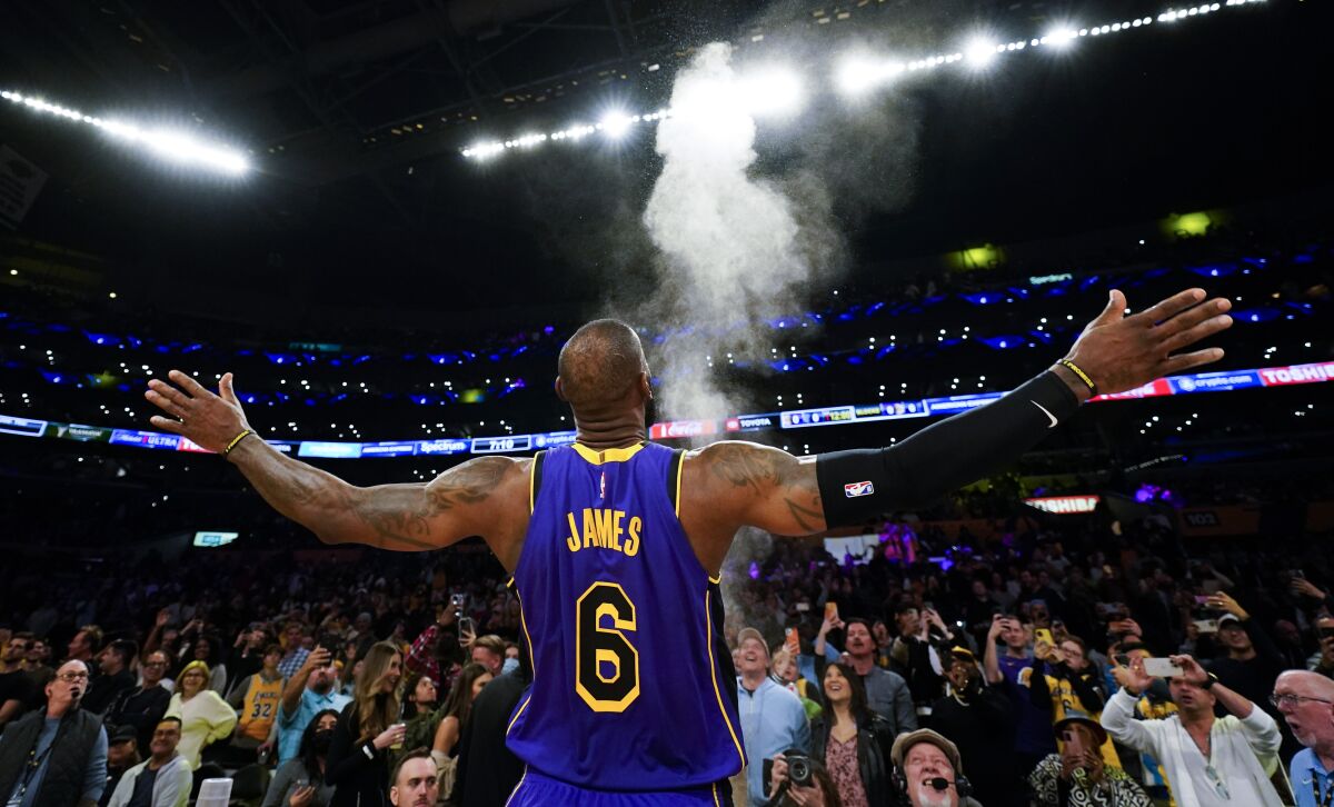 Lakers forward LeBron James throws powdered chalk in the air before an NBA basketball game against the Memphis Grizzlies.