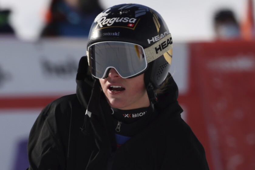 Switzerland's Lara Gut-Behrami grimaces in the finish area after crashing during an alpine ski, women's World Cup super-G in St. Moritz, Switzerland, Sunday, Dec. 12, 2021. (AP Photo/Marco Trovati)