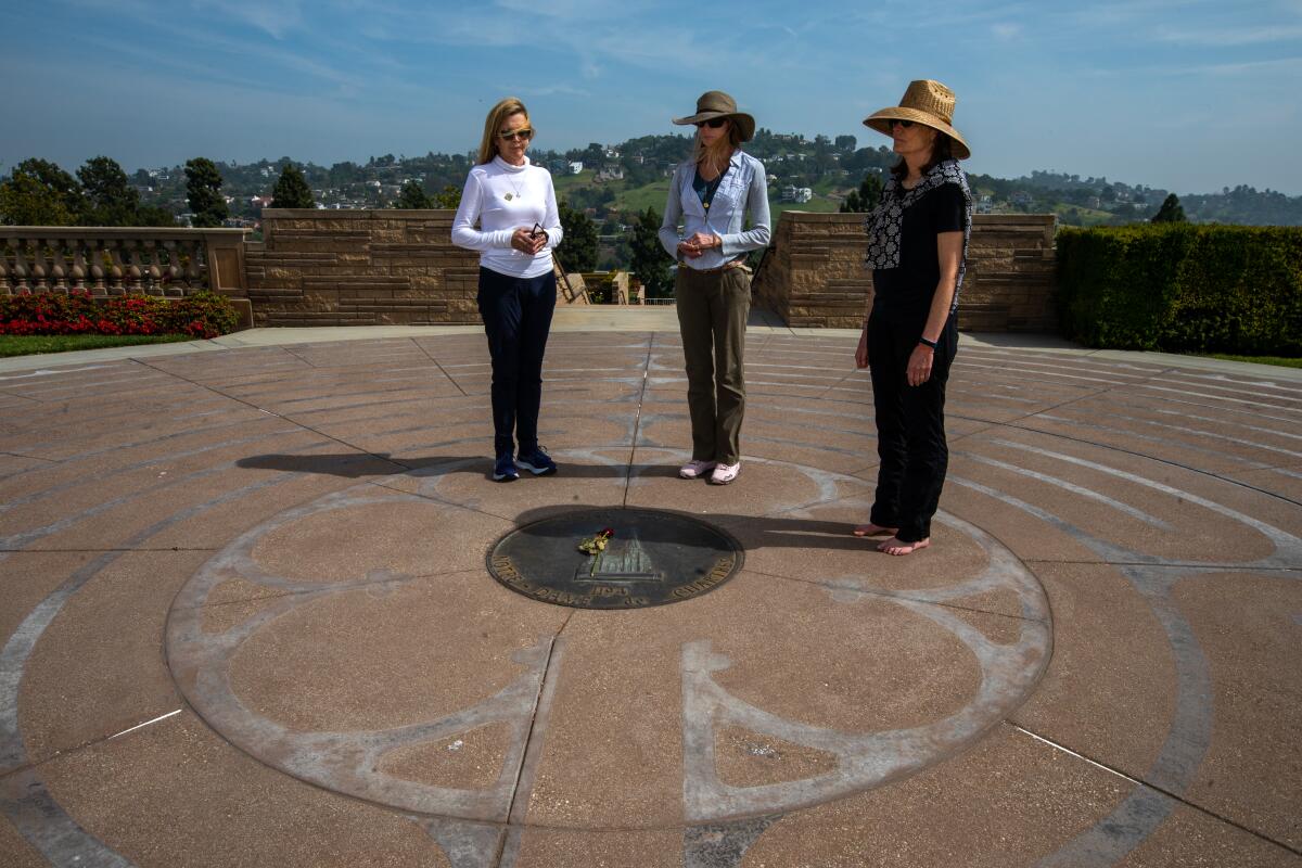 Three women stand in the center of a labyrinth at Forest Lawn in Glendale.