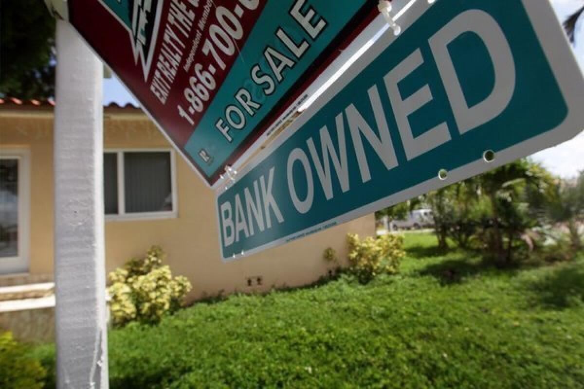 A Bank Owned sign is seen in front of a foreclosed home in Miami in September.