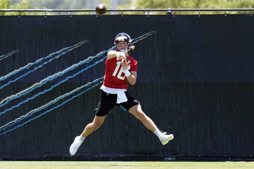 Jacksonville Jaguars quarterback Trevor Lawrence (16) throws a pass during an NFL football rookie minicamp, Saturday, May 15, 2021, in Jacksonville, Fla. (AP Photo/John Raoux)