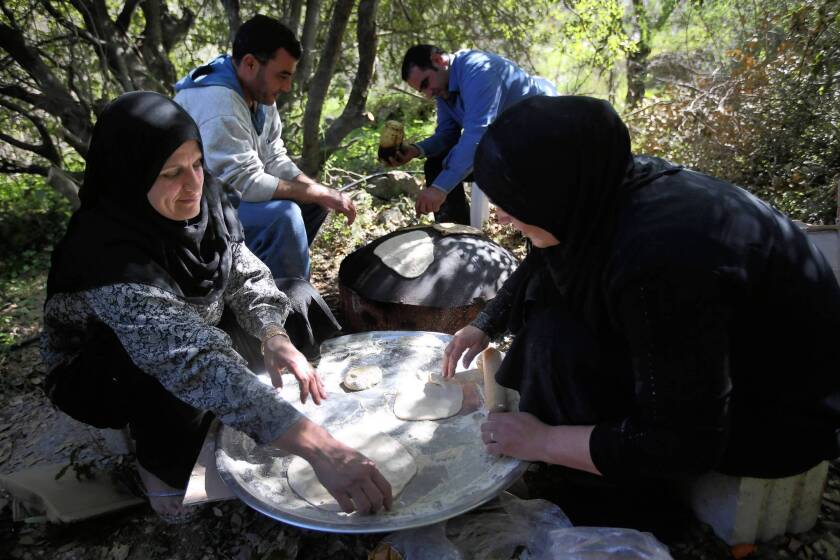 Syrian refugee women in Ketermaya village in Lebanon prepare flatbread for lunch for the visiting United Nations high commissioner for refugees, Antonio Guterres.